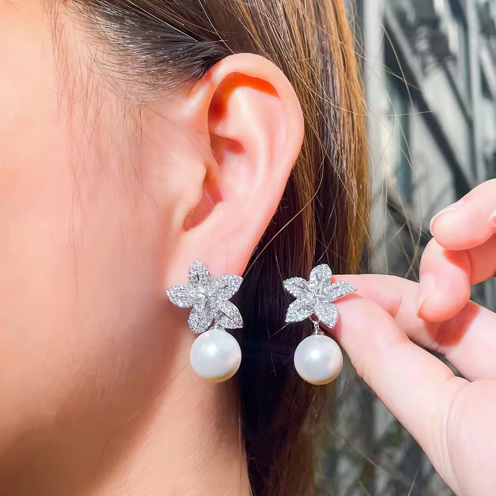 White flower pearl and diamond earring.