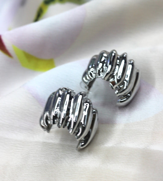 Silver stud with irregular wrinkles