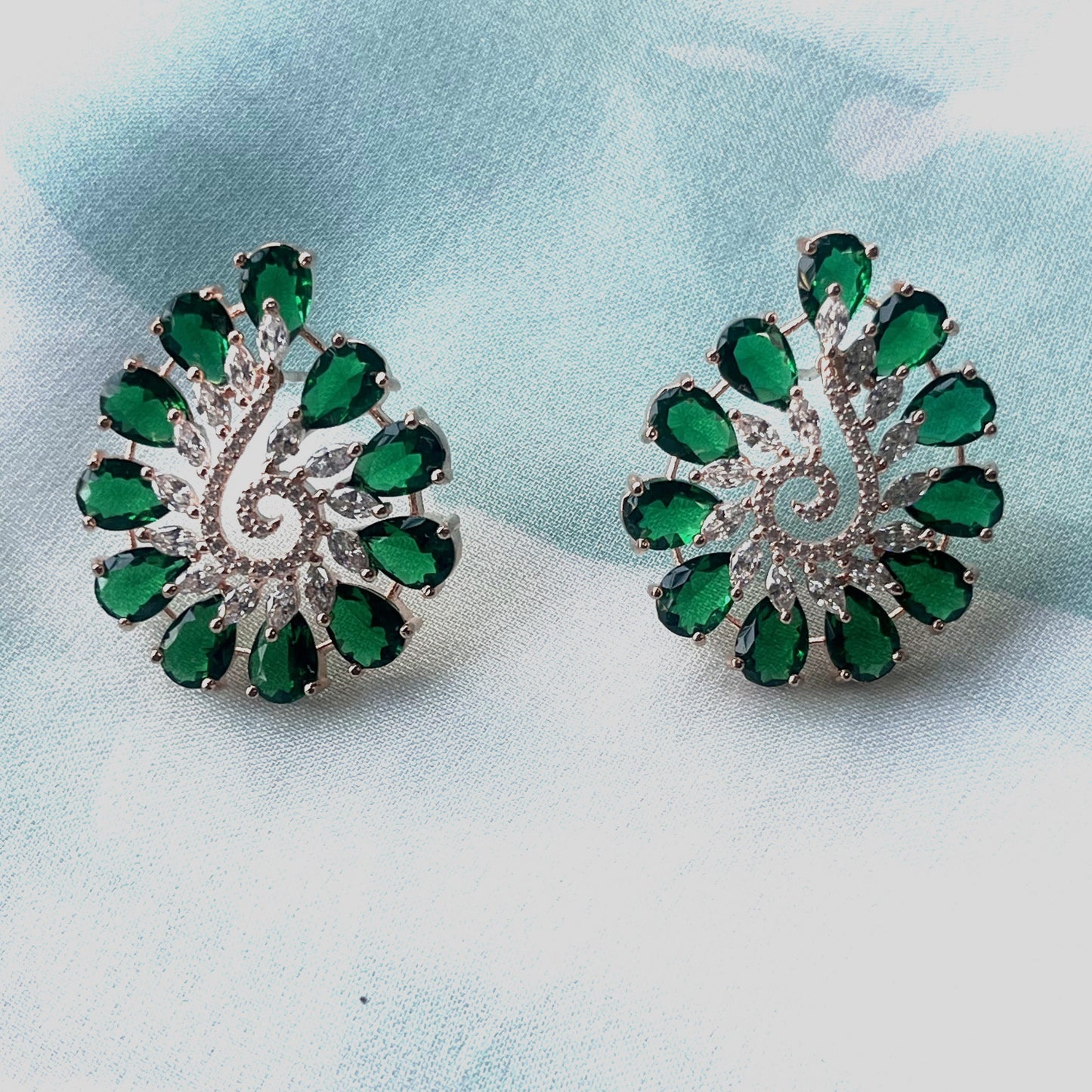 Green color flower shaped stud earring with emeralds