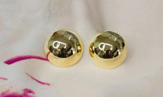 Gold colored ball shaped earrings